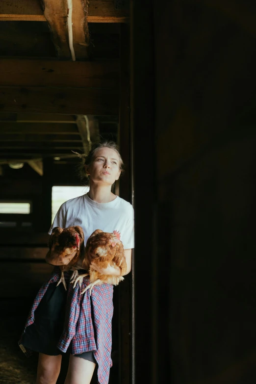 a woman holding a chicken in a barn, a portrait, by Jessie Algie, pexels contest winner, greta thunberg, wandering, australian, ::