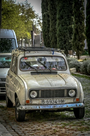 an old car is parked on a cobblestone street, tehran, ukraine. photography, square, van