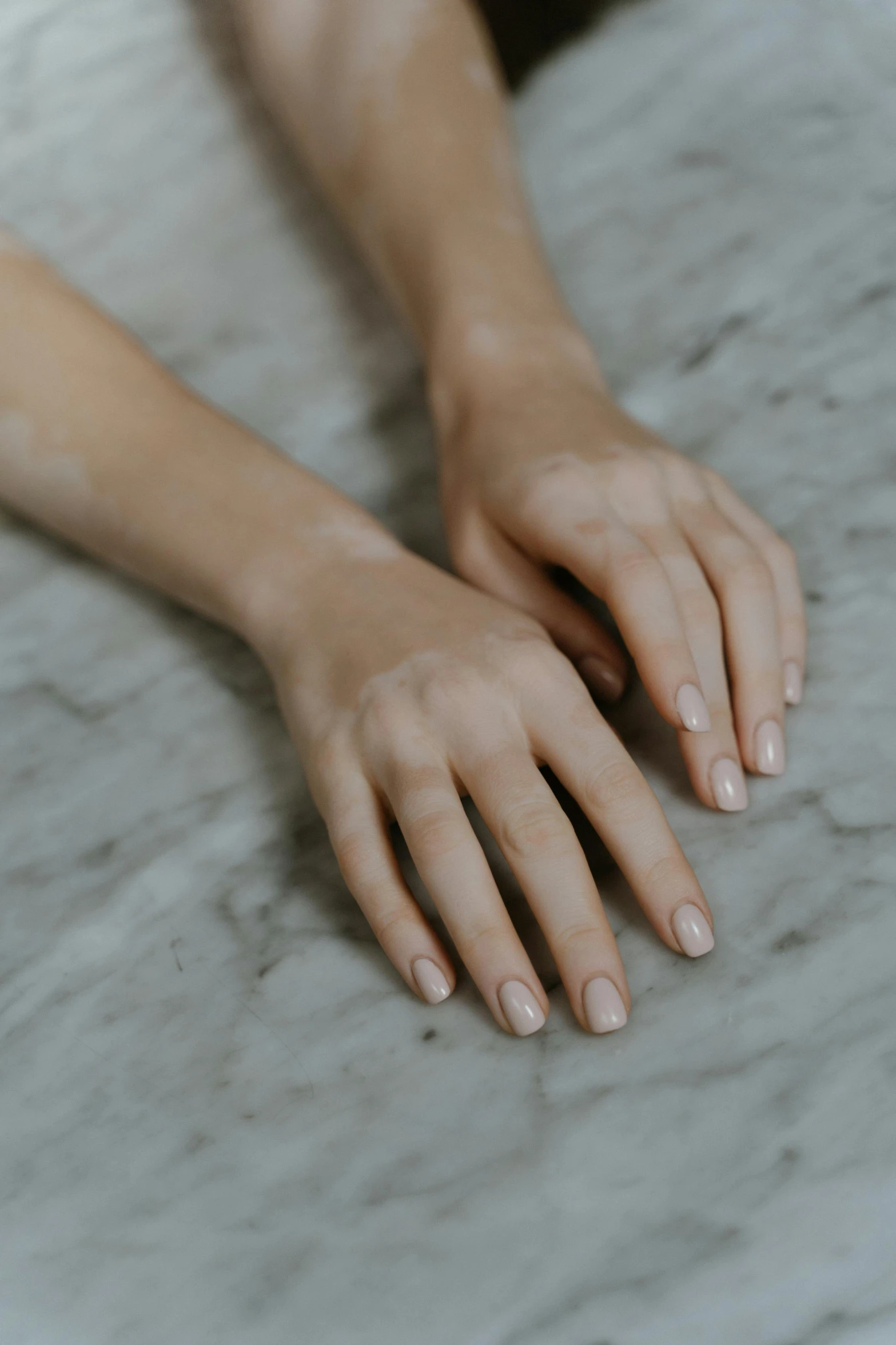 a close up of a person's hands on a table, porcelain skin tone, silicone skin, perfectly poised, overview