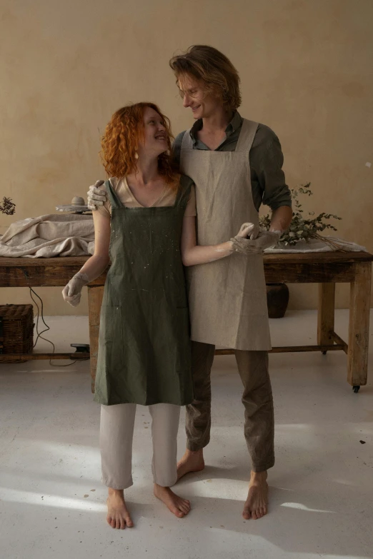 a couple of women standing next to each other, a portrait, inspired by Jules Bastien-Lepage, featured on pinterest, renaissance, blacksmith apron, clay material, happy couple, organic dress