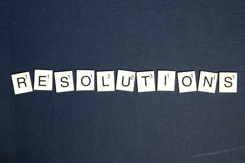 a close up of a piece of paper with the word resolutions written on it, a picture, pixabay, knolling, blue colored, square enix, revolution