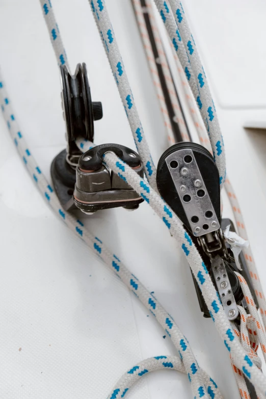 a close up of a rope on a boat, ratchet straps, detailed product image, white mechanical details, sigma 55”