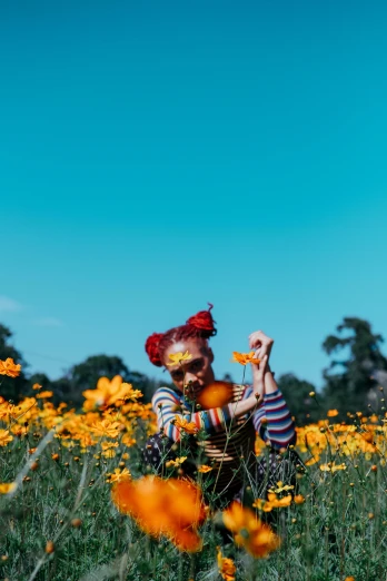 a woman sitting in a field of yellow flowers, pexels contest winner, color field, clowns, cyan and orange, toys, trippie redd