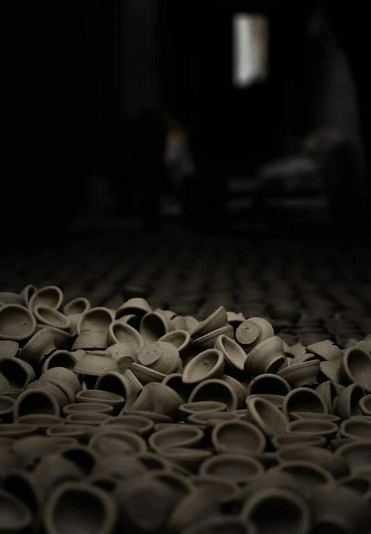 a pile of clay pots sitting on top of a floor, a picture, inspired by Ai Weiwei, unsplash contest winner, in a dark warehouse, c 4 d ”, coffee cups, holes