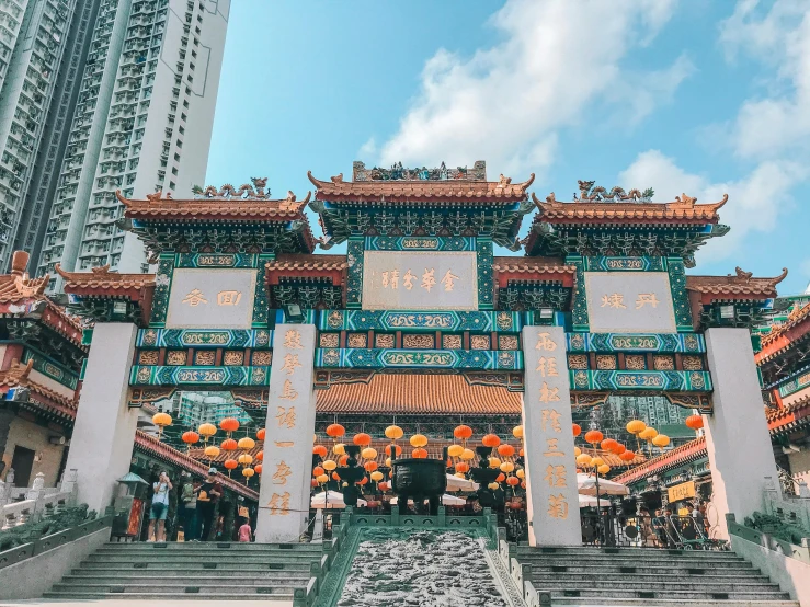 a group of people standing in front of a building, a photo, pexels contest winner, cloisonnism, chinese lanterns, hong kong buildings, turquoise and orange, 🦩🪐🐞👩🏻🦳