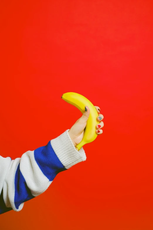 a close up of a person holding a banana, trending on pexels, pop art, primary colors are white, plastic toy, reds), sleek hands