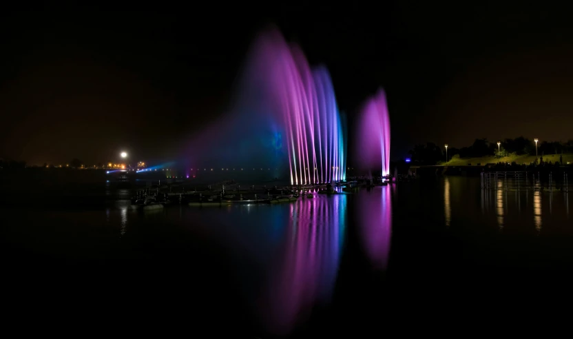 a colorful fountain is lit up at night, a hologram, pexels contest winner, hurufiyya, light purple mist, waterscape, taken with sony alpha 9, dramatic lighting - n 9