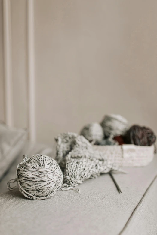 a bunch of balls of yarn sitting on top of a bed, unsplash, white and silver, delightful surroundings, digital image, cottagecore