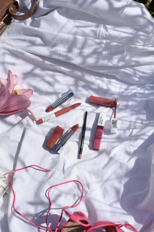 the contents of a purse are laid out on a blanket, a picture, by Gavin Hamilton, trending on pexels, lipstick, ulzzang, white and blood color scheme, summer sunlight