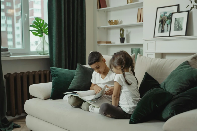 a couple of kids sitting on top of a couch, by Adam Marczyński, pexels contest winner, arts and crafts movement, short bookshelf, high quality upload, lounge room, promotional image