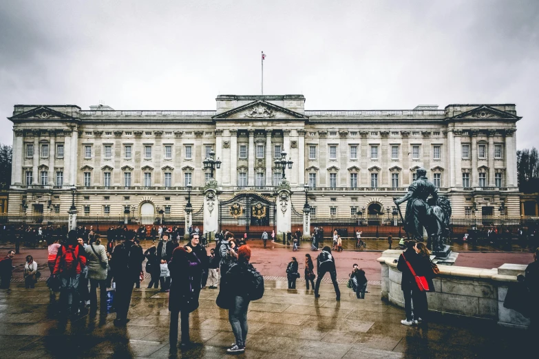 a group of people standing in front of a large building, pexels contest winner, visual art, queen of england, thumbnail, square, nice slight overcast weather