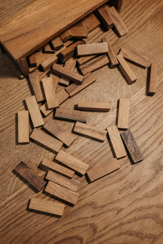 a pile of wooden crosses sitting on top of a wooden floor, a jigsaw puzzle, by Joel Shapiro, unsplash, process art, cigarrette boxes at the table, oak, detail shot, xylophone