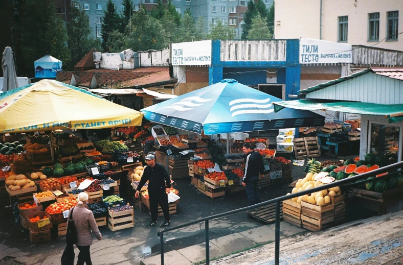 a market filled with lots of fruits and vegetables, a photo, by Julia Pishtar, unsplash, russian city of the future, square, 2000s photo, blue