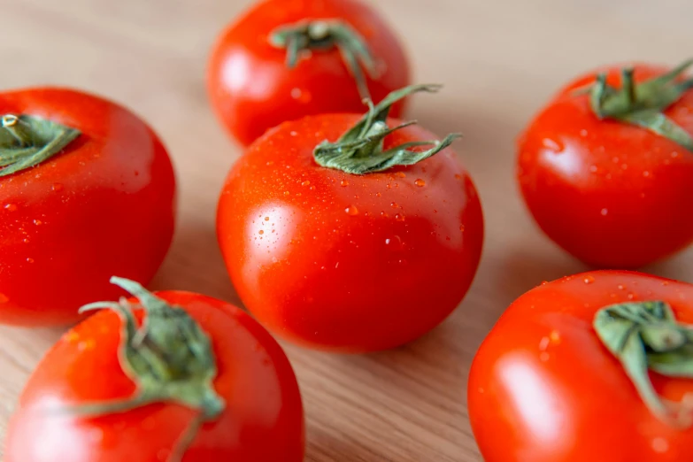 a bunch of tomatoes sitting on top of a wooden table, by Julian Hatton, unsplash, extra detail, dezeen, extra crisp, official product photo