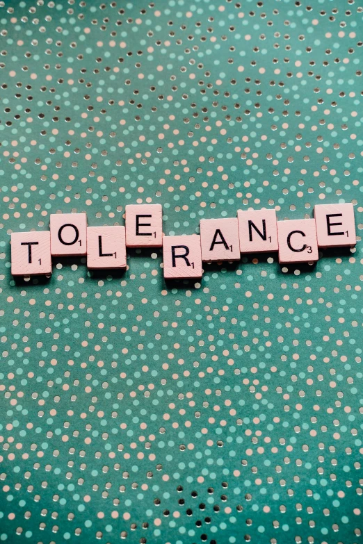 the word tolerance spelled in scrabbles on a green background, an album cover, inspired by Gustave Boulanger, trending on unsplash, renaissance, life is strange, placards, non-binary, spanners