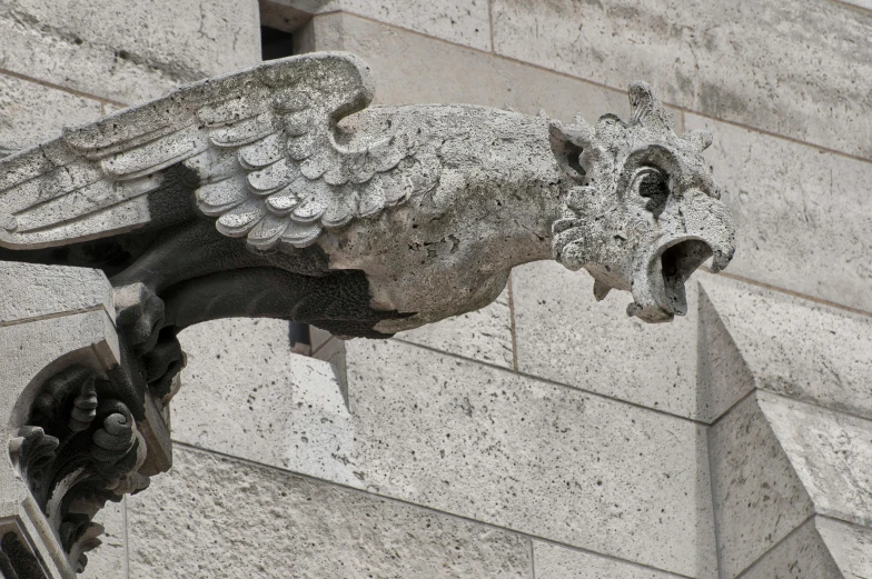 a statue of a bird on the side of a building, dragon shaped helmet, inspiring gothic architecture, on a large marble wall, sqare-jawed in medieval clothing