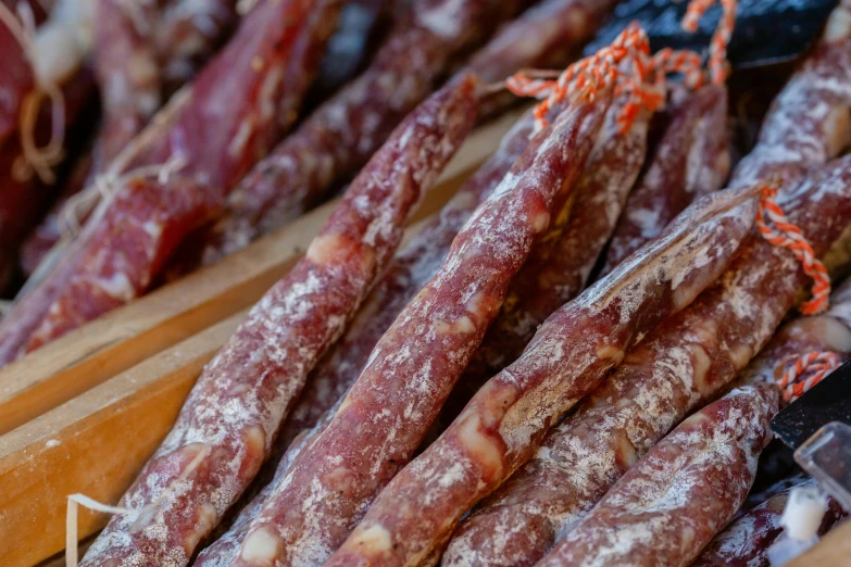 a close up of a bunch of sausage sticks, by Julian Hatton, pexels, art nouveau, sichuan, 🦩🪐🐞👩🏻🦳, woodfired, sparkling