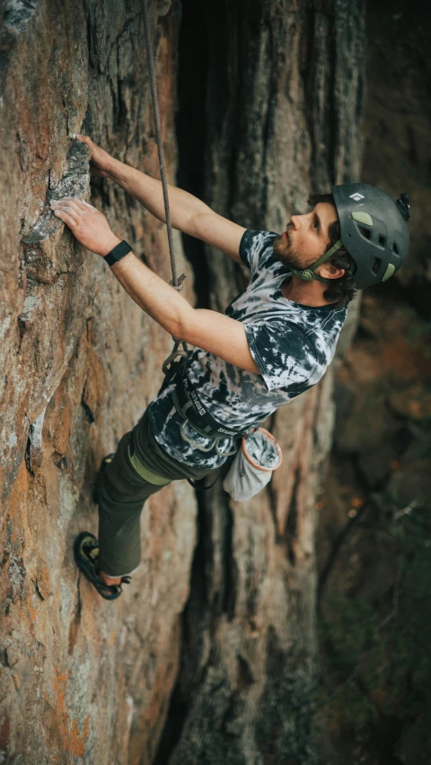 a man climbing up the side of a rock, pexels contest winner, renaissance, wearing adventure gear, in australia, patterned, avatar image