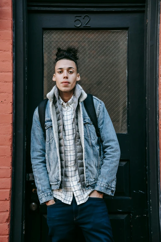 a man with a backpack standing in front of a door, an album cover, trending on unsplash, portrait androgynous girl, mixed race, flannel, humans of new york