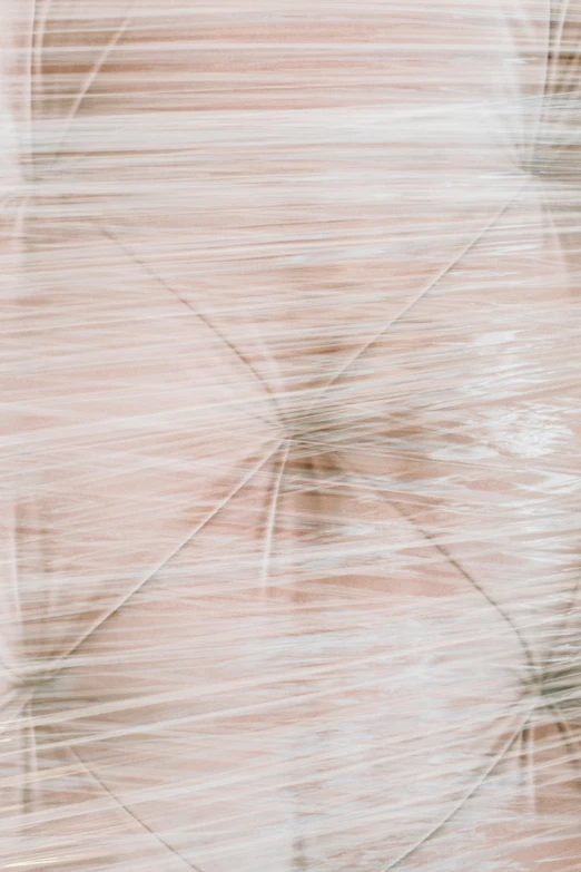 a blurry picture of a person holding an umbrella, an abstract drawing, inspired by Cornelia Parker, trending on unsplash, abstract illusionism, hair texture, plastic wrap, light pink hair, centered close-up