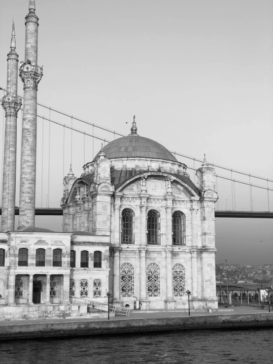 a black and white photo of a large building, a black and white photo, inspired by Fikret Muallâ Saygı, hurufiyya, 2 5 6 x 2 5 6, ( ( photograph ) ), tall arches, building along a river