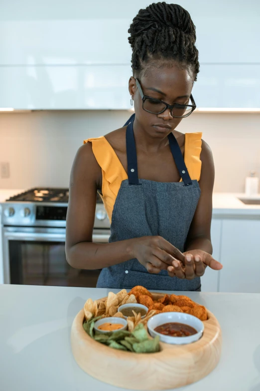 a woman standing in front of a plate of food, hands on counter, crisp clean shapes, ashteroth, concentration