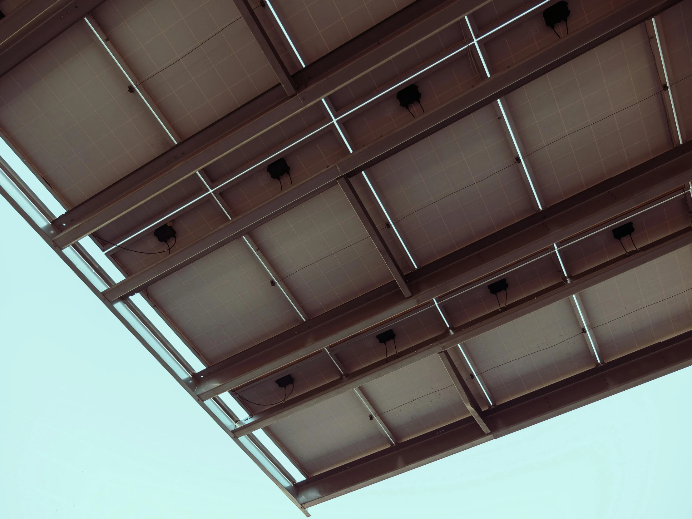 a man riding a skateboard up the side of a ramp, an album cover, by Carey Morris, unsplash, brutalism, sky made of ceiling panels, awnings, brown, close - up photo