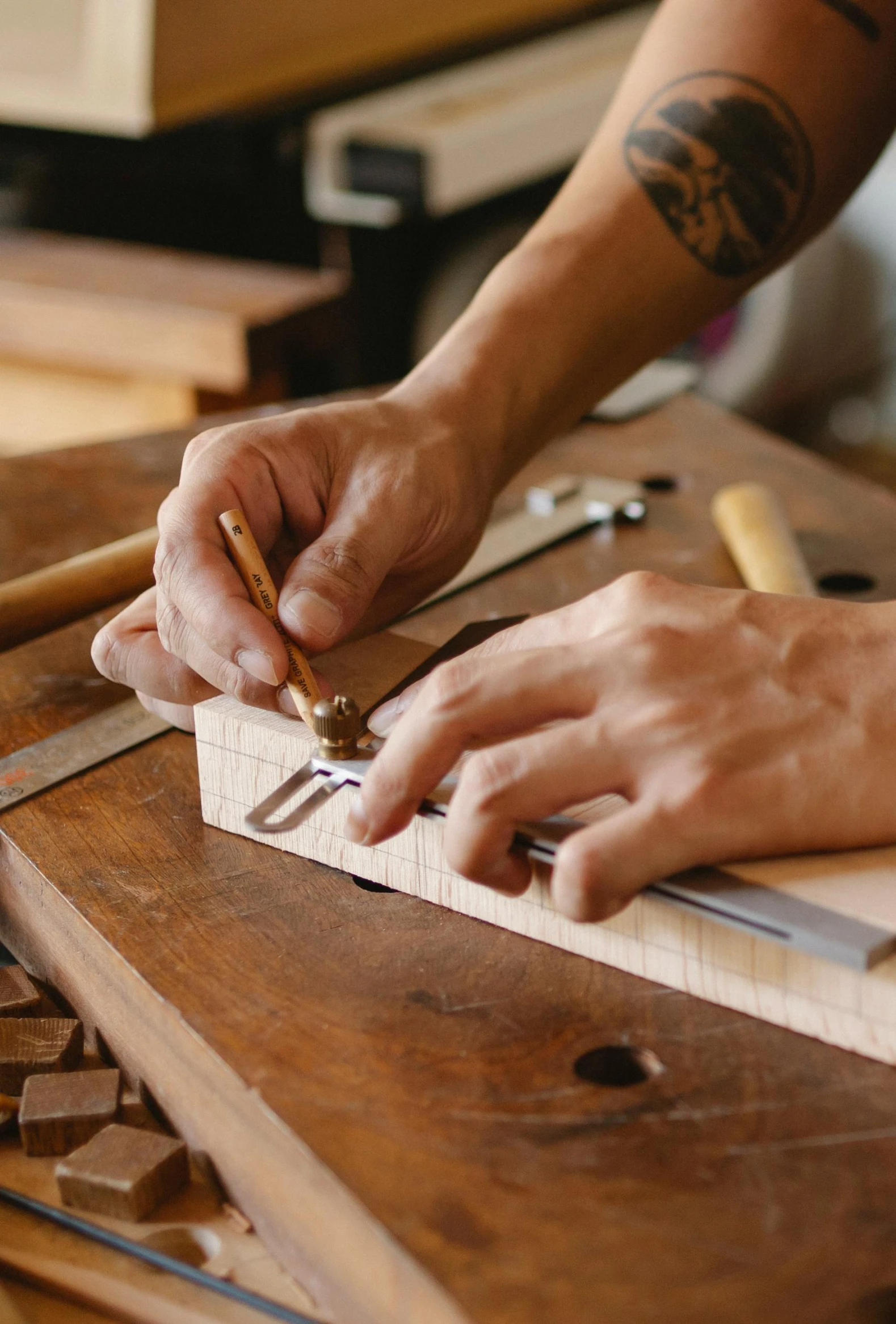a close up of a person working on a piece of wood, trending on pexels, arts and crafts movement, intricate writing, intarsia, thumbnail, hardware