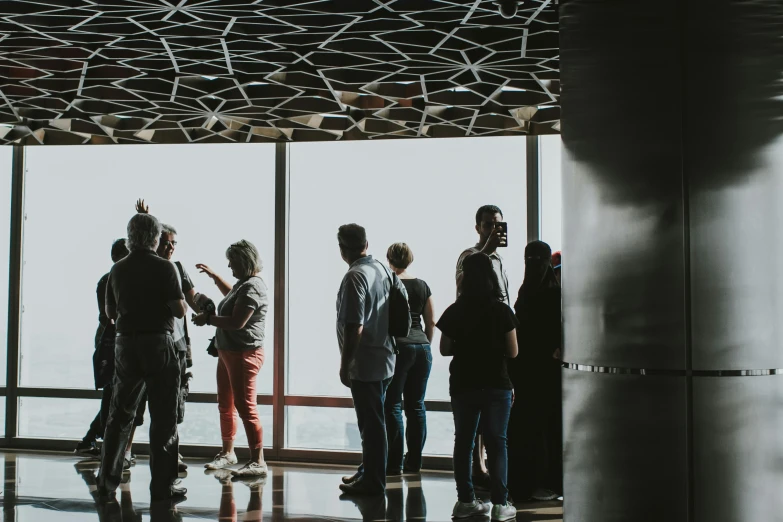 a group of people standing in front of a window, happening, observation deck, unsplash photography, standing in corner of room, thumbnail
