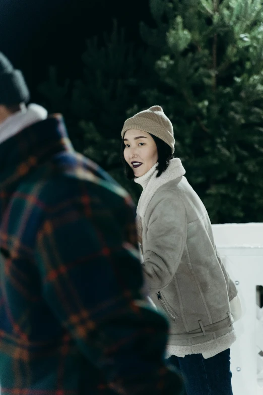 a man and a woman playing frisbee in the snow, trending on pexels, happening, film still of gal gadot, wearing wool hat, li bingbing, standing outside a house