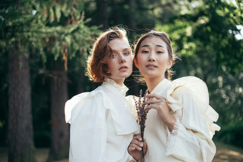 two women standing next to each other in a forest, a portrait, by Emma Andijewska, unsplash, renaissance, korean women's fashion model, wearing a linen shirt, puff sleeves, ruan kia and john singer sargent