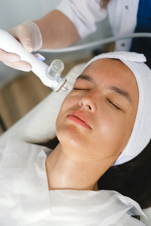 a woman getting a facial treatment at a beauty salon, featured on reddit, renaissance, freezing, dynamic closeup, square, vibrating