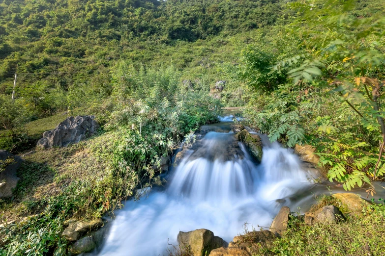 a river running through a lush green forest, an album cover, pexels contest winner, hurufiyya, vietnam, thumbnail, fountain of water, white water