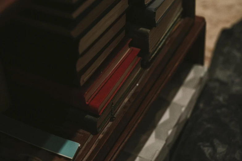 a stack of books sitting on top of a wooden bench, an album cover, unsplash, tonalism, screenshot from a movie, the librarian, cinematic close shot, movie still 8 k
