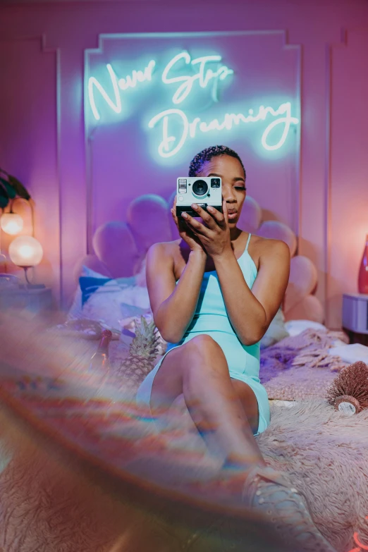 a woman sitting on top of a bed holding a camera, an album cover, violet and aqua neon lights, aka dream, standing in front of a mirror, trending on instagram!