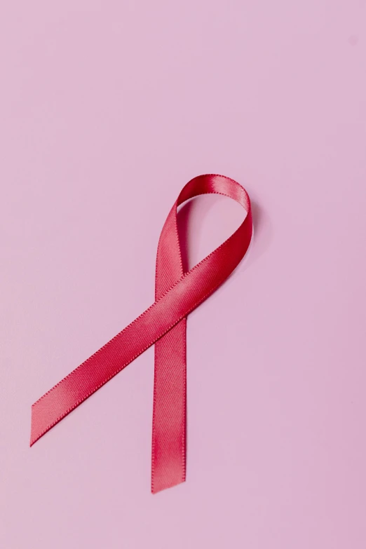 a red ribbon on a pink background, a picture, by Carey Morris, trending on pexels, tumors, on black background, profile picture, front facing