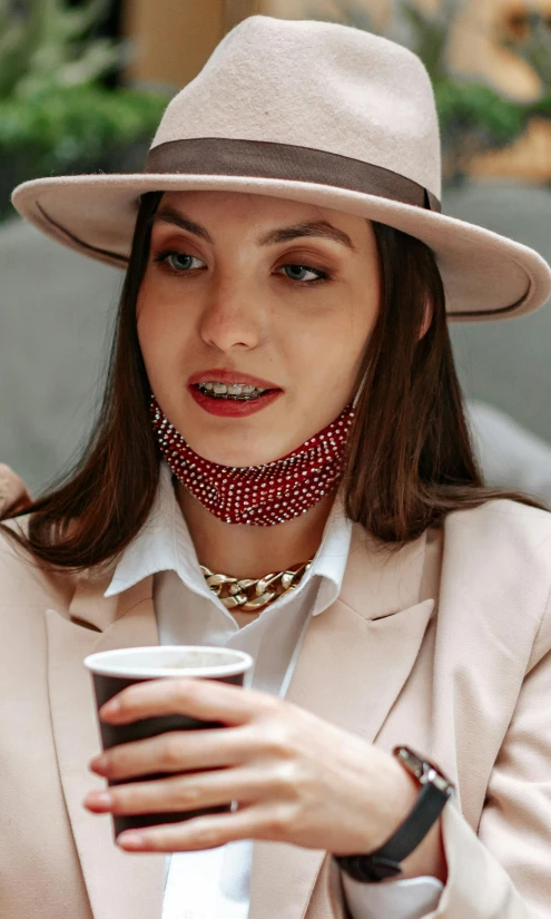 a woman in a hat holding a cup of coffee, by Julia Pishtar, trending on pexels, renaissance, jeweled choker, red mesh in the facede, double chin, smart casual