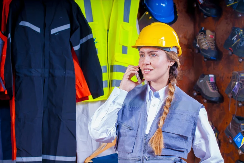 a woman in a hard hat talking on a cell phone, a photo, by Julia Pishtar, shutterstock, arbeitsrat für kunst, girl wearing uniform, sustainable materials, wearing a fancy dress, worksafe. instagram photo