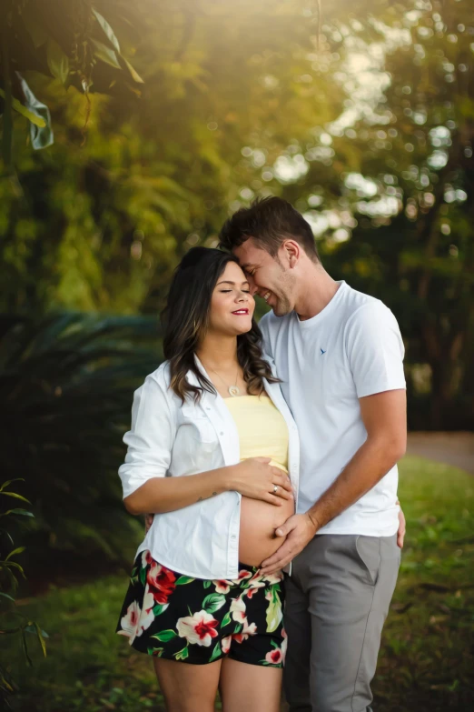 a man and woman standing next to each other, a picture, pexels contest winner, happening, pregnant belly, brunette, australian, relaxed pose