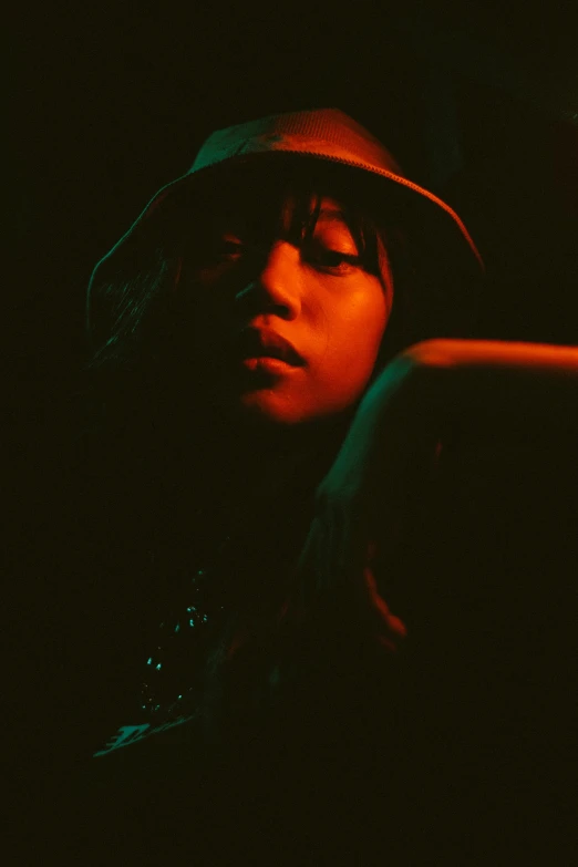 a woman in a hat looking at a cell phone, an album cover, by Tadashi Nakayama, unsplash, posing in dramatic lighting, sza, ((portrait)), asian woman