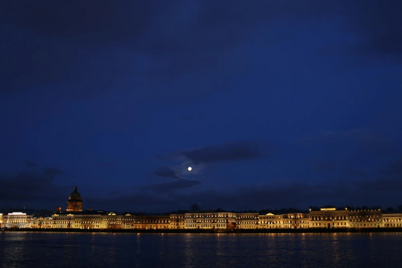 a large body of water next to a city at night, inspired by Canaletto, pexels contest winner, hyperrealism, saint petersburg, moon lighting, hegre, national geographic photo