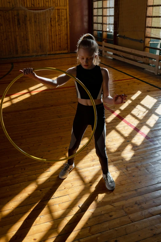 a young girl playing with a hula hoop, by Sven Erixson, local gym, greta thunberg, high quality photo, square