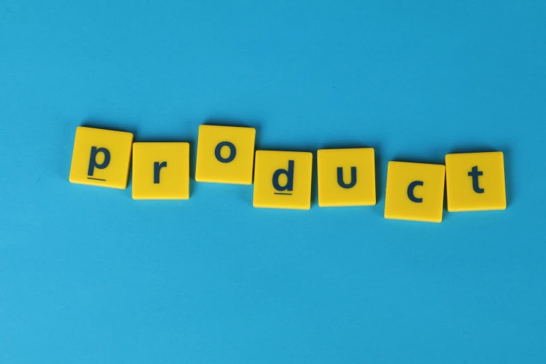 the word product spelled in scrabbles on a blue background, by Carey Morris, pexels, permaculture, music video, display item, process