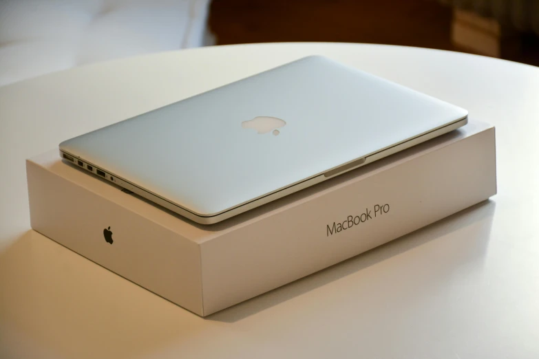 a laptop sitting on top of a box on a table, by Carey Morris, unsplash, iphone 1 3 pro max, square, cream, in 2 0 1 2