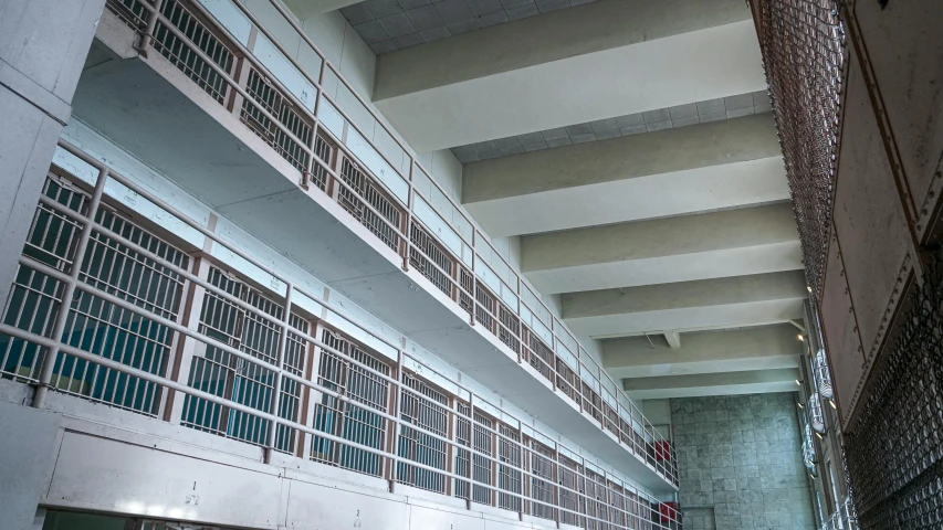 the inside of an old jail cell block, unsplash, tall metal towers, 2000s photo, fan favorite, bridges and railings