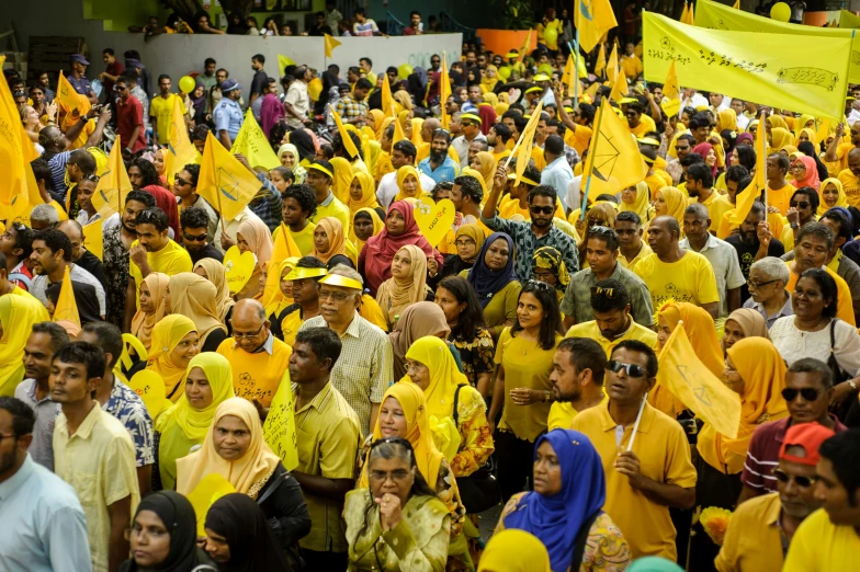 a large group of people dressed in yellow, hurufiyya, reclections, kuala lumpur, avatar image
