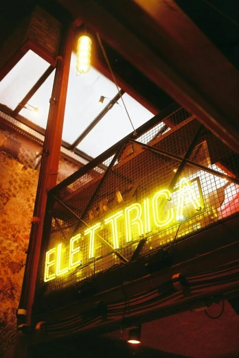 a neon sign hanging from the side of a building, electricity, eterea, epicurious, trick