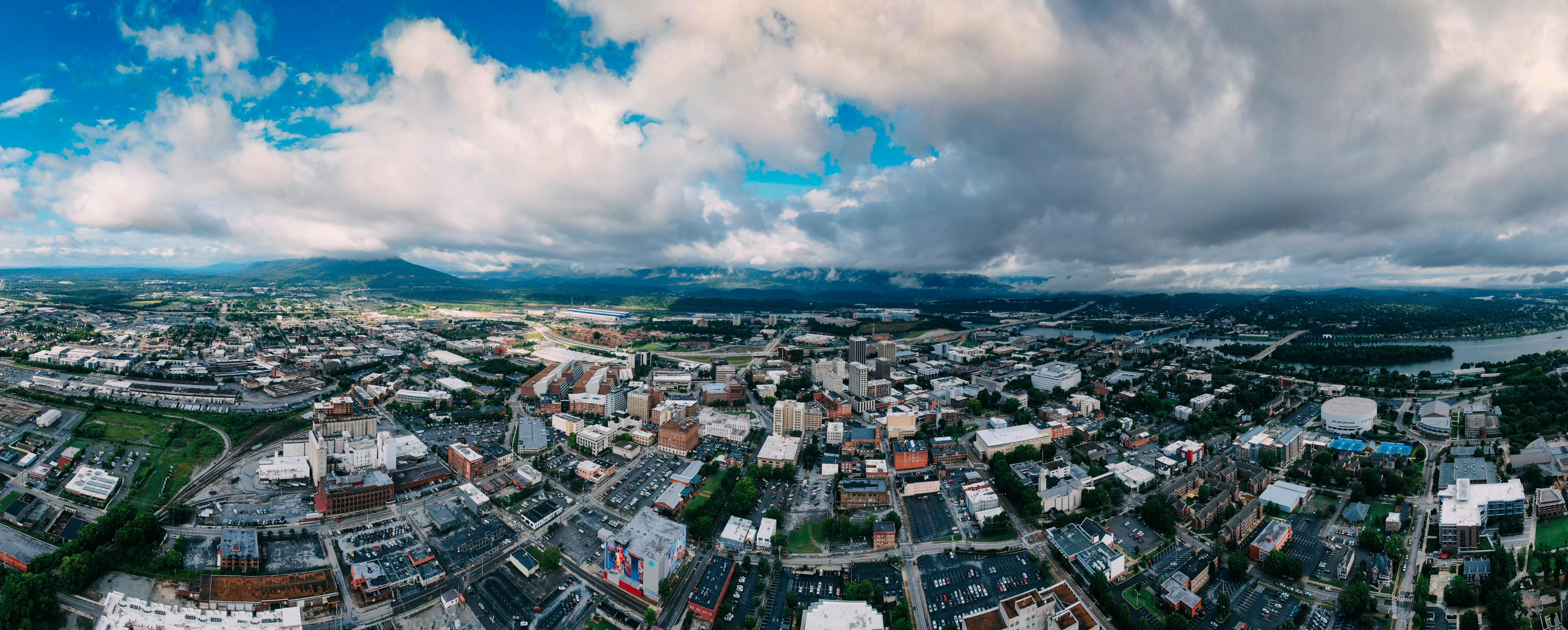 a panoramic view of a city on a cloudy day, a tilt shift photo, unsplash, visual art, alabama, big sky, drone photograpghy, university