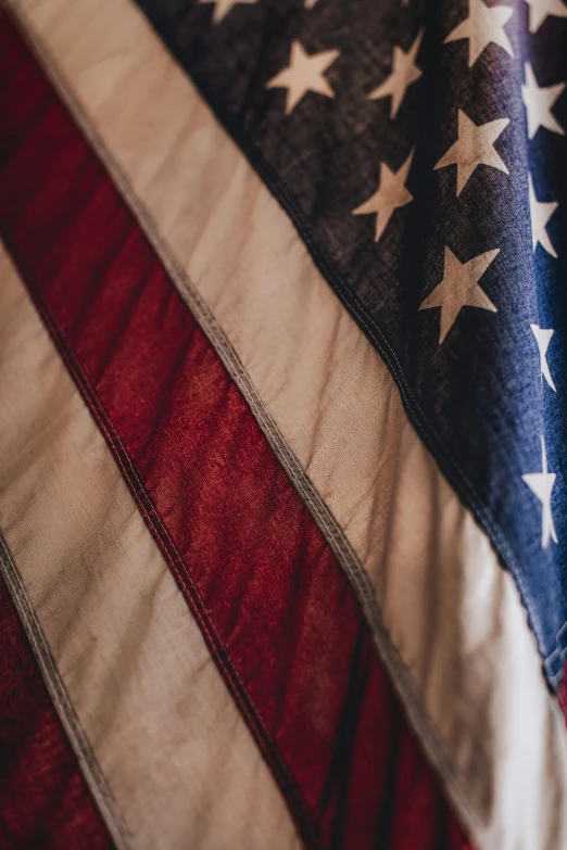 a close up of an american flag on a bed, profile image