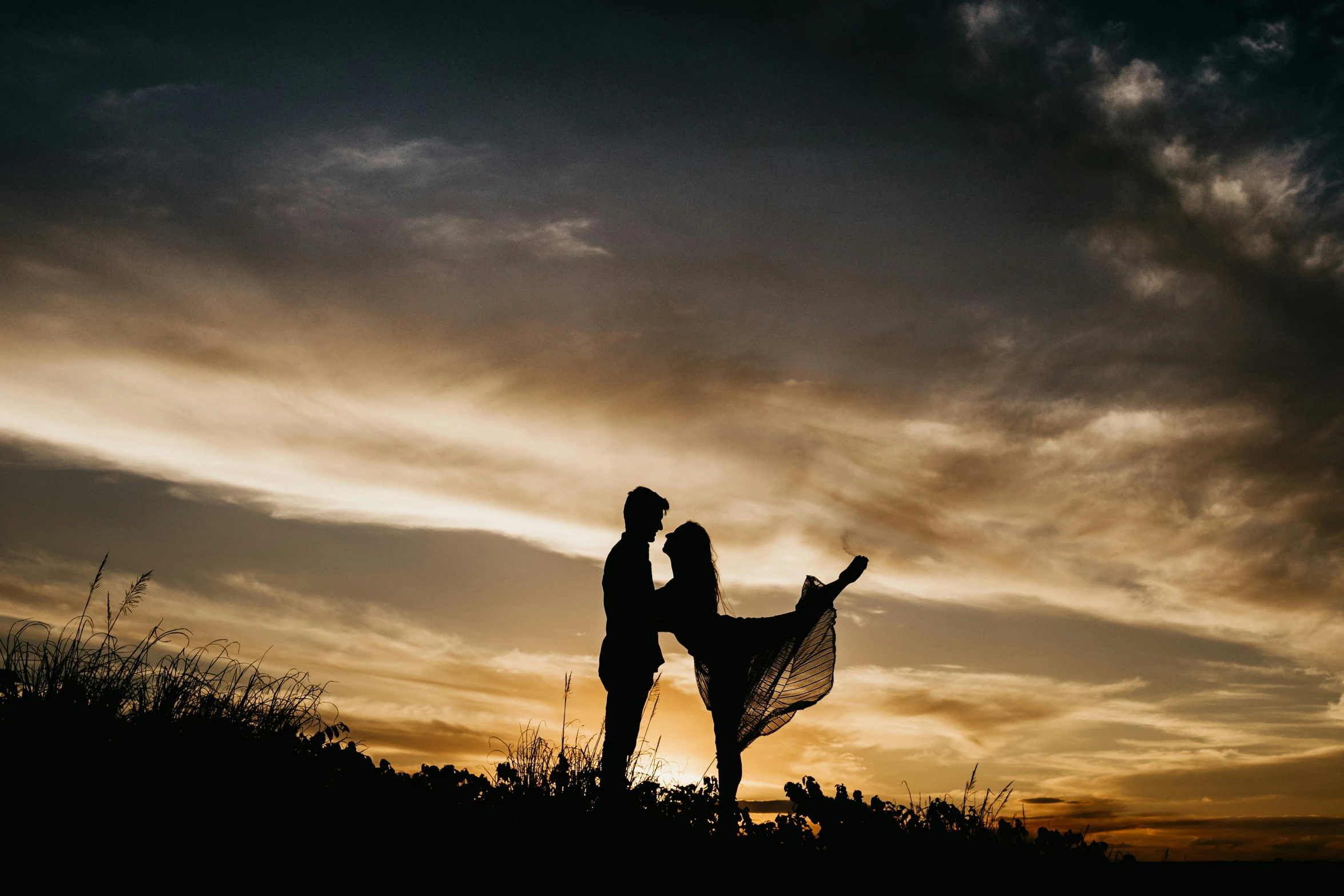 a couple standing on top of a hill at sunset, by Matt Cavotta, pexels contest winner, romanticism, twirling, low-angle, 15081959 21121991 01012000 4k, bottom angle